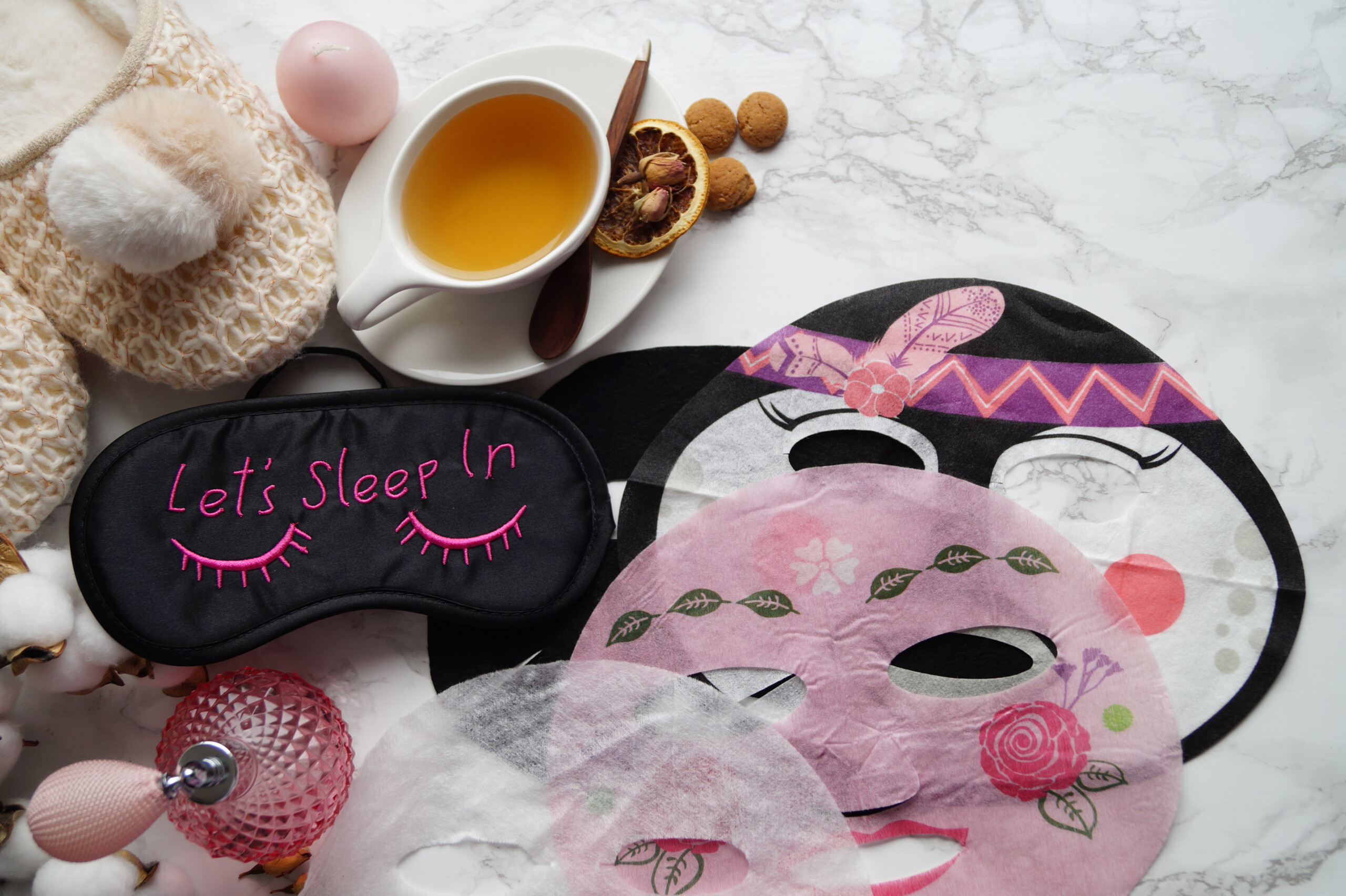 mascarillas faciales sobre la cama junto a un te