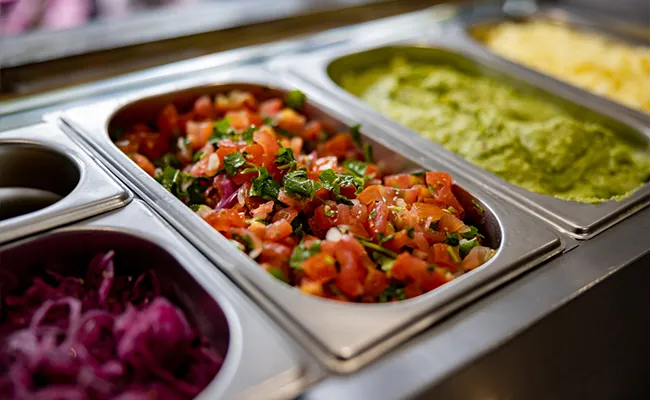 bandejas con toppings de tacos, guacamole y chile